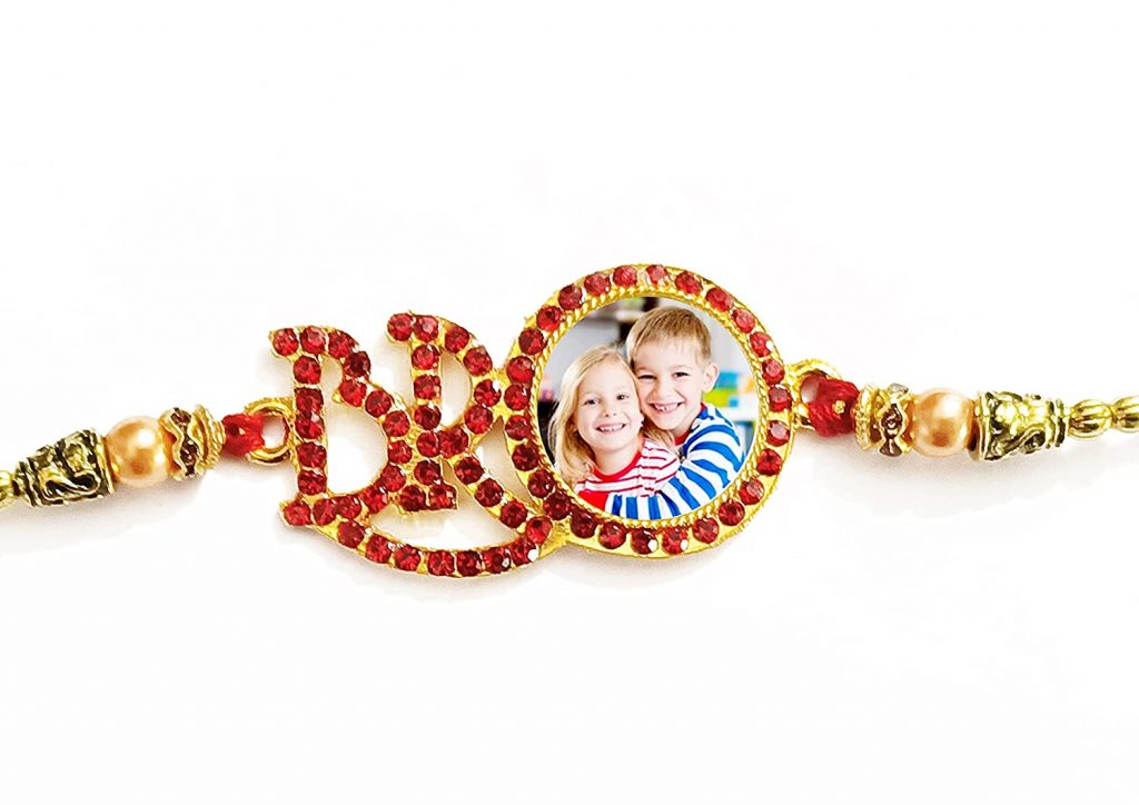 What could be better than this? Lord Ganesh in the form of Rakhi will be the most sacred thing on this planet. This will also give positive vibes to your brother whenever he will look at this Rakhi. So, this is something which you could consider for buying online. Tying a Ganesh shaped Rakhi will also protect your loving brother from all the evil elements and negative energy of this society.

Personalized Photo Shaped Designer Rakhi